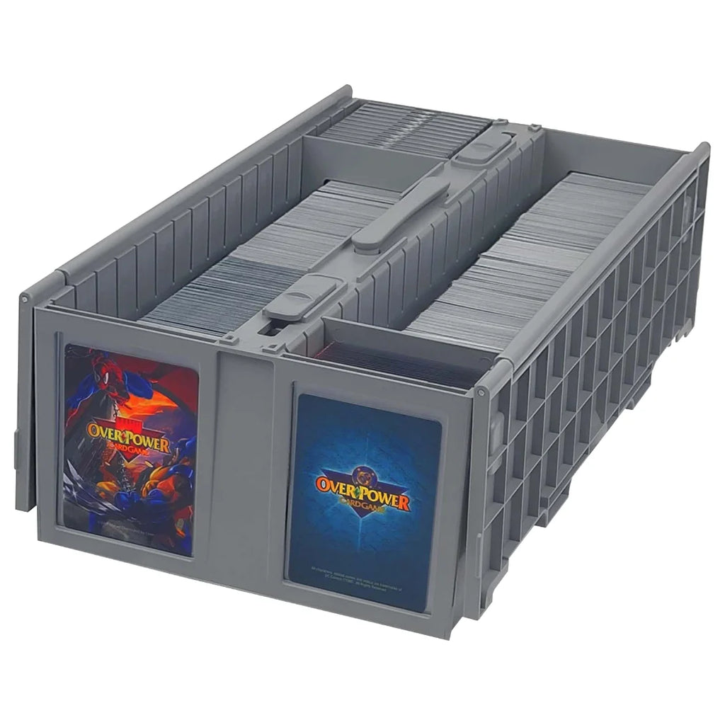 A BCW gray plastic card storage organizer with two front windows displaying card decks. The left window shows a red and blue 'Overpower' card deck, and the right window shows a blue card deck with the 'Overpower' logo.