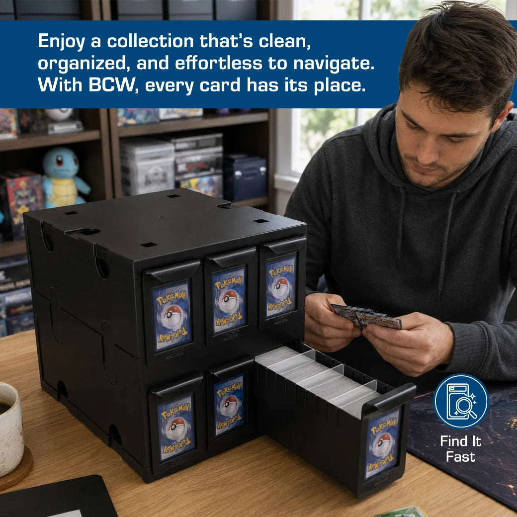 A man sits at a wooden desk organizing Pokémon trading cards in a black plastic BCW card storage box with multiple labeled drawers. A blue promotional banner for BCW Supplies at the top reads, 'Enjoy a collection that's clean, organized, and effortless to navigate.